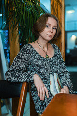Portrait of a beautiful middle-aged woman in a cafe.