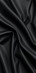 Fototapeta premium Luxurious black satin fabric draped elegantly, showcasing deep texture and sheen under soft light