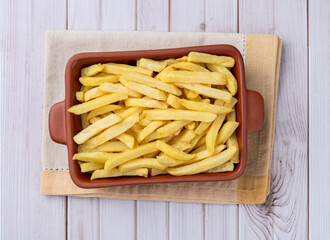 French fries in a plate over wooden table