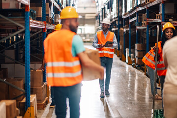 Warehouse workers and manager working together organizing goods distribution