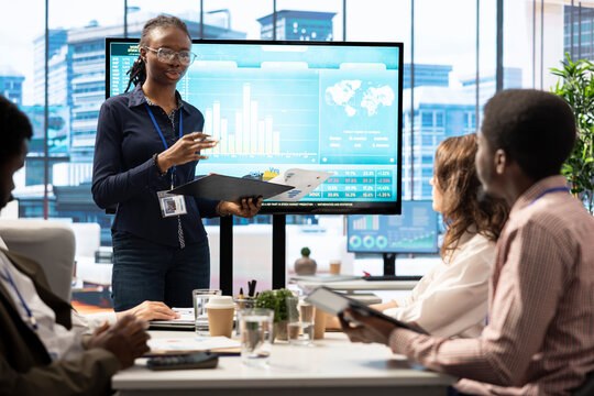 Group of business associates discussing project development plans, leveraging big data and advanced analytics to make informed decisions and enhance workflow efficiency. Multinational company. - Powered by Adobe