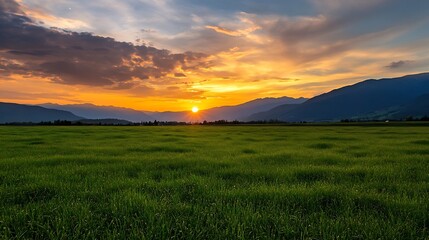 Obraz premium Breathtaking view of a tranquil landscape during sunset with vibrant colors illuminating the mountains and field : Generative AI