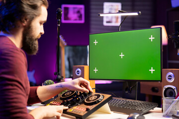 Skilled sound engineer watching online master class lesson on greenscreen pc, working on music...