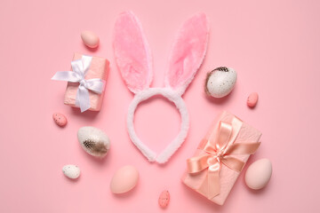 Bunny ears with Easter eggs and gift boxes on pink background