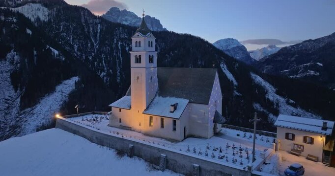 Aerial drone view of the Eglise de Sainte-Lucie in the Colle Santa Lucia comune in Dolomites, Italy