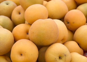 Close up of fresh Asian Pears for sale at Farmer's Market. Pyrus pyrifolia is a species of pear tree native to southern China and northern Indochina