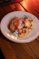 Baked turkey and cauliflower are a delicious dish on the menu at the restaurant. A beautiful and delicious photo for a menu, culinary website, or an advertisement for catering establishments.