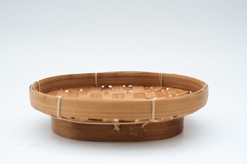 Wicker tray or bamboo basket is Indonesian people handmade and old culture isolated on white background closeup.