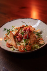 Caesar salad with bacon is mouthwatering and delicious. A beautiful perfect photo for a cafe or restaurant menu, advertisement, culinary website. Suitable for design