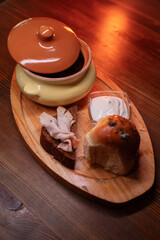 Restaurant dish borscht, delicious bread with bacon, sour cream, bun. A delicious photo for a menu, culinary website, or an advertisement for catering establishments.