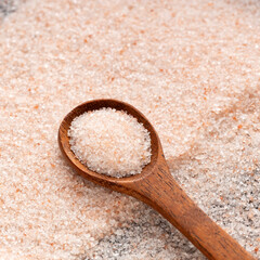 Fine salt and pink Himalayan crystals on the spoon.