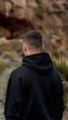 back view of a male model wearing a black hoodie