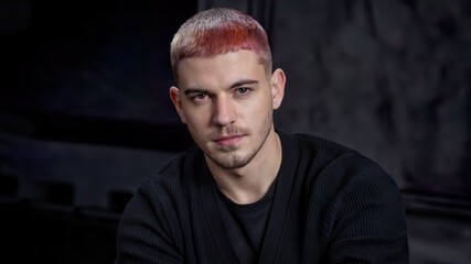 a young, handsome man with short, colored hair