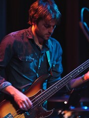 Dynamic Musician Playing Electric Bass Guitar in Colorful Stage Lights at Concert : Generative AI