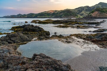 Coastal rocks and pools at low tide. Tranquil scene of the ocean's edge. Nature's beauty. Elliot Bay, Rawhiti, Northland, New Zealand