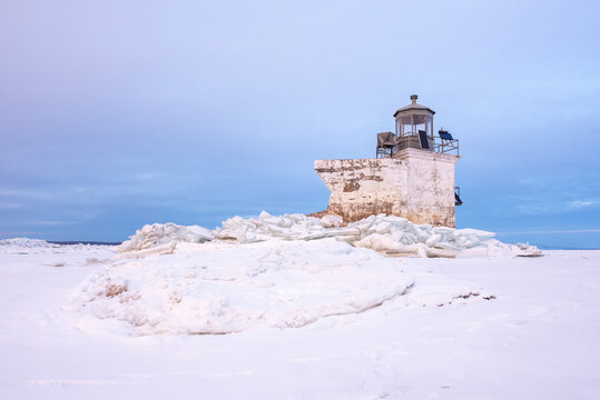 In winter, the frozen St Lawrence river at the level of the Saint-Pierre lake with the lighthouse of Nicolet in front of the Parc &Eacute;comaritime de l'Anse-du-Port (Nicolet, Qu&eacute;bec, Canada)