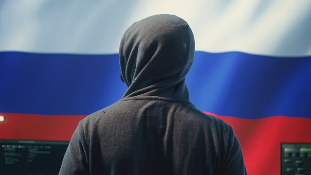Expert in governmental hacking room with a Russian flag on big screen, individual in cyberwarfare and propaganda. Russian federation hacker works on sabotage and political manipulation. Camera B.