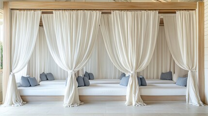 Stylish resort cabana with soft white curtains and cozy lounge seating.