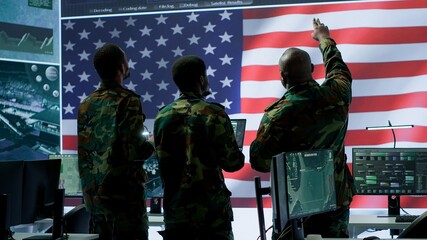 Military personnel work in a high tech environment safeguarding classified data and managing cybersecurity operations to defend against cyber attacks and digital warfare threats. Camera A.