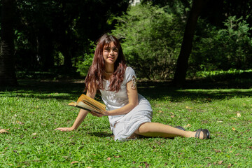 Young woman reading a book in a peaceful park setting