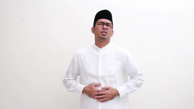 Muslim man suffering stomach ache