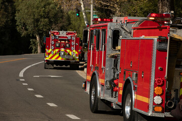 Red fire engines respond to the scene of an emergency.