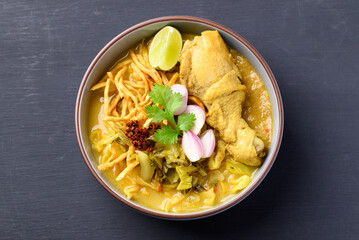 Northern Thai food (Khao Soi), Spicy curry noodles soup with chicken, Local Thai food, Table top view