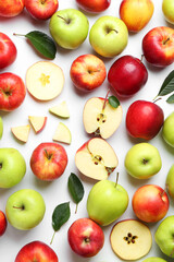 Flat lay composition with whole and cut apples on white background