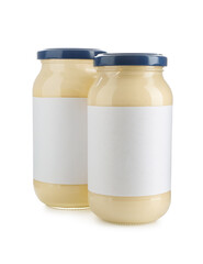 Tasty mayonnaise sauce in glass jars with blank labels isolated on white