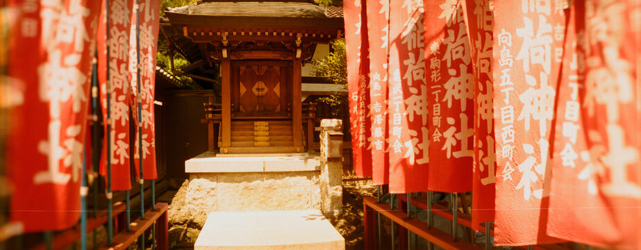 Entrance of a shrine lined with flags, Tokyo Prefecture, Japan.