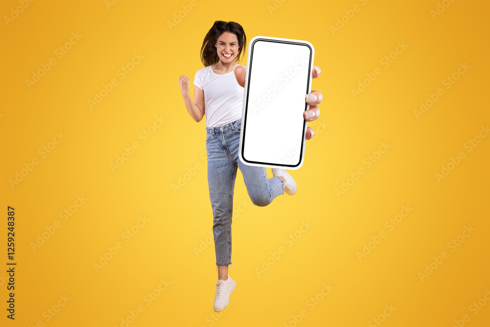 Poster yes. full body length portrait of joyful woman jumping up, making winner gesture with clenched fist 