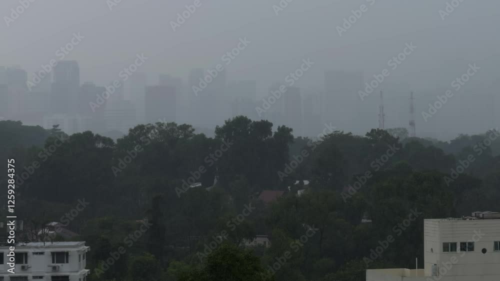 Poster Aerial misty view of Singapore residential buildings and houses with green vegetation during rain