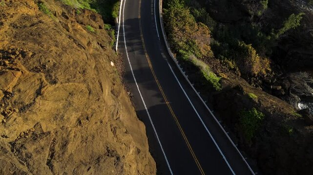 Aerial view of a Coastal highway in Hawaii next to ocean
