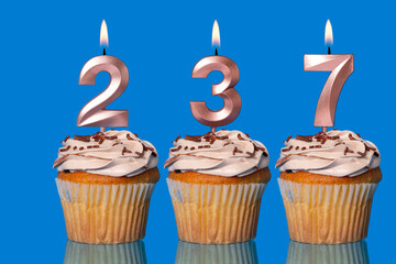 Birthday Cupcakes With Candles Lit Forming The Number 237.