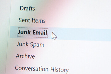 Close up computer or laptop monitor screen focus on spam or junk email folder, mouse clicker hover on spam button.