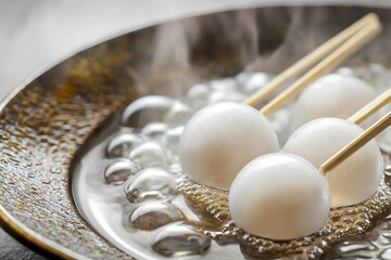 A highly detailed food portrait of dango skewers, emph.asizing the smoothness of their surface and the intricate beauty of the plate beneath them  