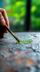 Hand paints fern leaf detail, closeup, nature background, art therapy