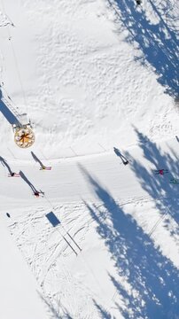 Aerial drone view of a ski resort in Col dei Baldi, Alleghe, in the Dolomites, Italy in daylight. Vertical