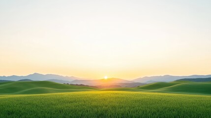 Serene sunrise over lush green hills with mountains in the background, evoking tranquility