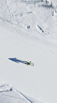 Aerial drone view of a ski resort in Col dei Baldi, Alleghe, in the Dolomites, Italy in daylight. Vertical