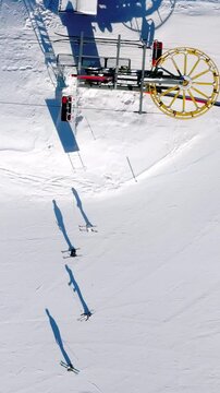 Aerial drone view of a ski resort in Col dei Baldi, Alleghe, in the Dolomites, Italy in daylight. Vertical