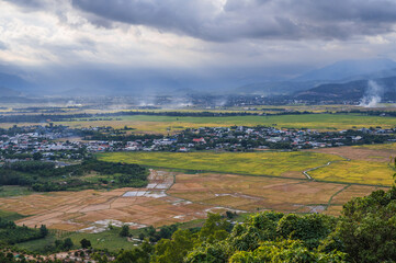 Fototapeta premium top view of rice fields with villages on background of mountains in Vietnam in Asia.
