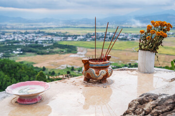 Incense sticks smoke on a Buddhist altar on pagoda in Vietnam in Asia.
