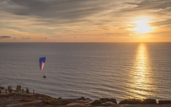 Parasailing or Hang Gliding off of cliff overlooking the Pacific Ocean in San Diego