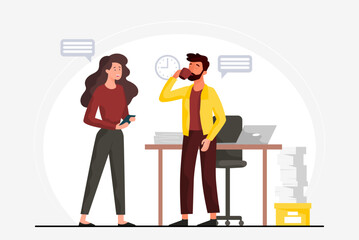 Office colleagues chatting near desk with papers and laptop. 