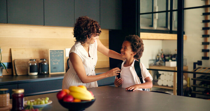 Backpack, school and mom with child in kitchen getting ready for morning routine, start day and learning. Family, home and mother with boy with bag for education, development and academy in house