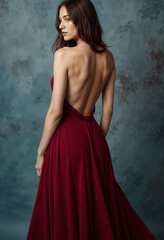 Elegant Woman in Maroon Backless Gown, Studio Portrait