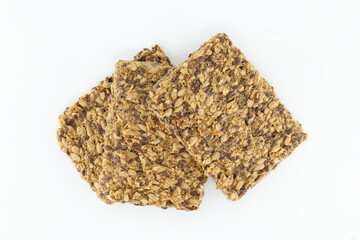 Delicious crunchy crackers with flax and sunflower seeds, perfectly stacked against a white backdrop
