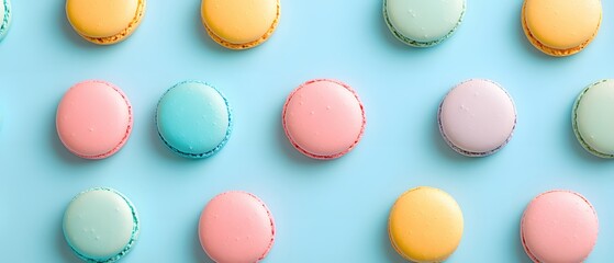 Obraz premium Pastel Delightful Macarons Arranged in a Neat Pattern on a Light Blue Background Sweet Treat
