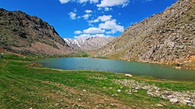 A serene seasonal lagoon nestled in rugged mountains under a vibrant blue sky with scattered clouds.
📍Sarpir, Hawraman Takht - Kurdistan 